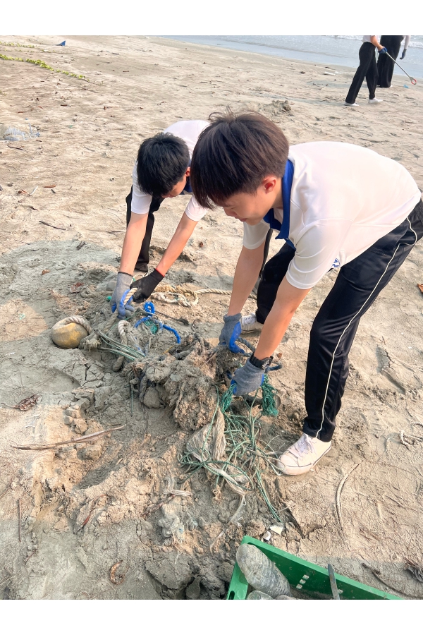 同学们合力拉出掩埋在沙土中的绳索，并将其妥善弃置，展现团队合作精神。